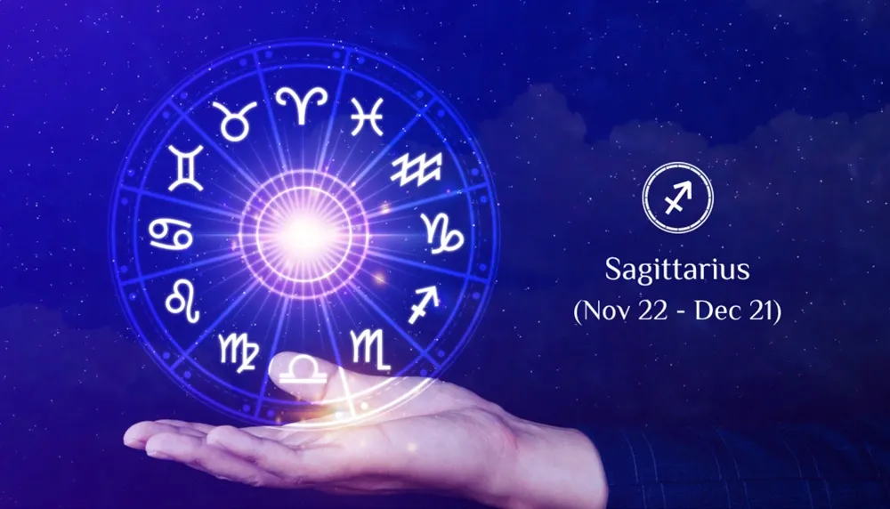 Hand holding a glowing zodiac wheel with Sagittarius symbol and dates (Nov 22 - Dec 21) on a starry background.